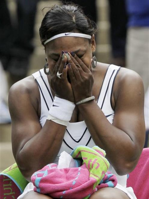Serena Williams of the US reacts after defeating France's Aravane Rezai in their first-round...
