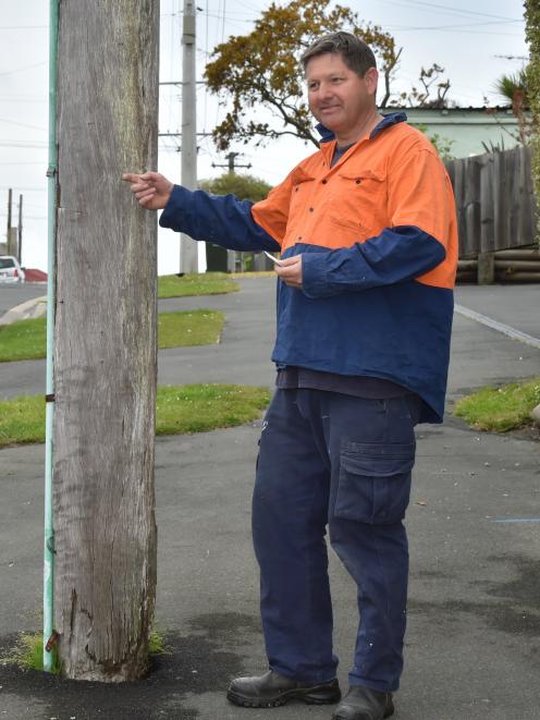 Eric Gotlieb is concerned about the safety of several power poles in his neighbourhood. Photo by Gregor Richardson.