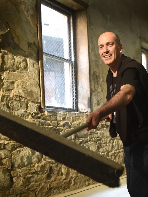 Arts Festival Dunedin director Nicholas McBryde sweeps the floor of the Athenaeum basement...