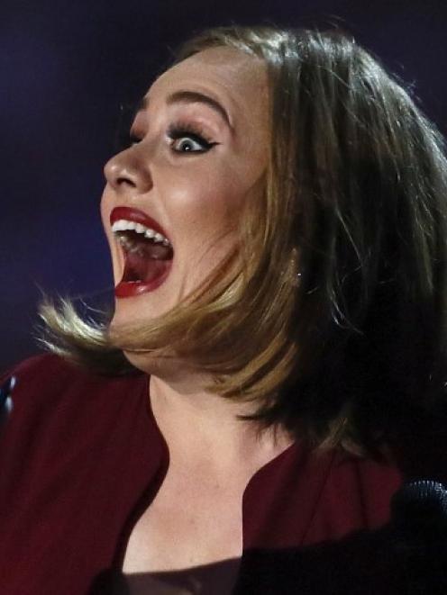 Adele prepares to accept the award for best British single. Photo Reuters