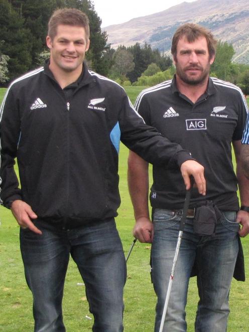 Former All Blacks captain Richie McCaw (left) and Andrew Hore relax during a game of golf in...