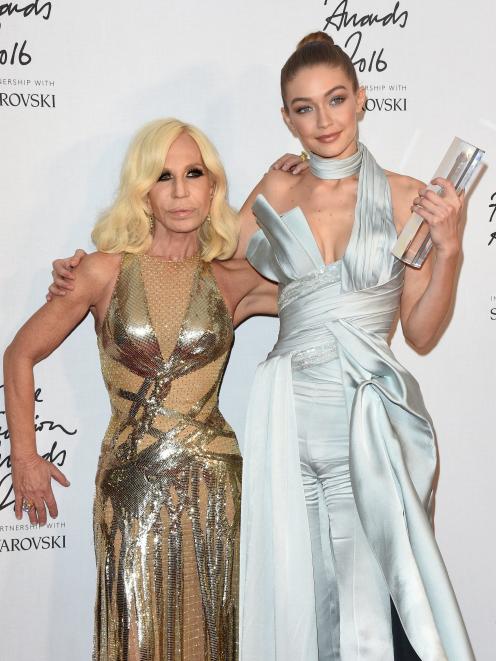 Model Gigi Hadid poses in the winners room with Donatella Versace after winning the International...