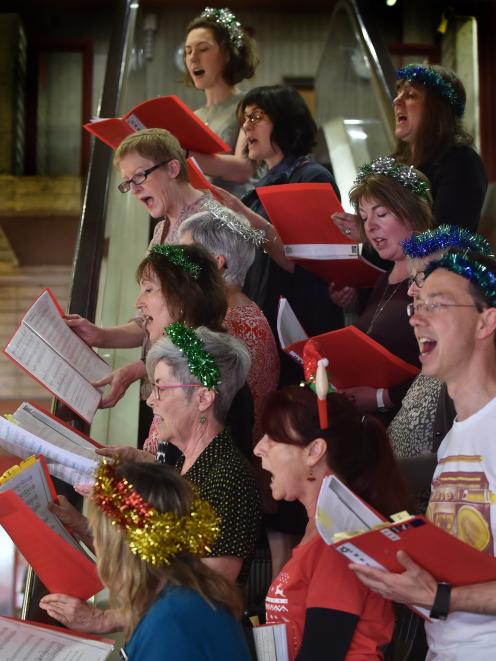 Pictured yesterday singing at the library are (clockwise, from top left) Beth Goulstone, Andrea Simonsen, Zaklina Cvjetan, Elizabeth Finney, Shirley Jones (obscured), Paul Hayton, Olga Hemmingsen, Su Ikin, Delyth Sunley, Glenda Rogers, Wendy Chapman (obsc