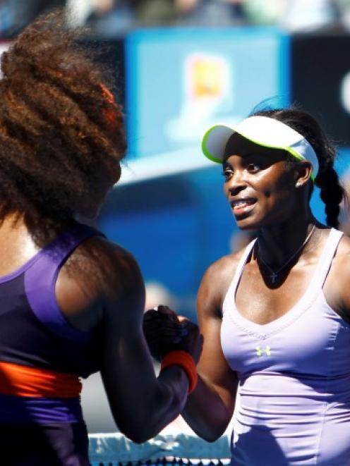 Sloane Stephens of the US (R) shakes hands with compatriot Serena Williams after defeating her in...