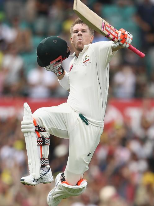 David Warner, of Australia, celebrates his century on day one of the third test match between...