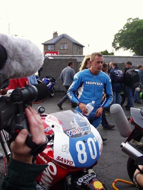 Paul Williams  surrounded by media during the Isle of Man TT motorcycle race in 1998.  