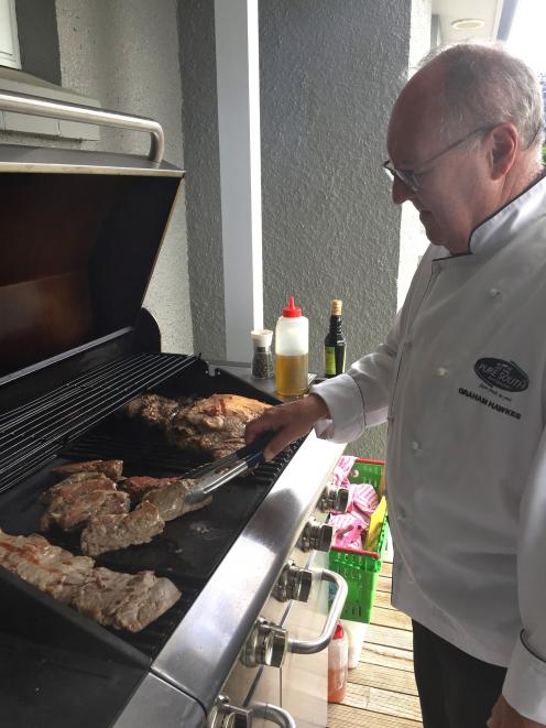 Chef Graham Hawkes barbecues Omega lamb during a gathering of farmers and chefs in Southland....