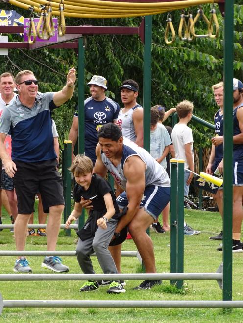 Cowboys lock and 2016 joint Dally M Medal winner Jason Taumalolo helps Arrowtown School pupil...
