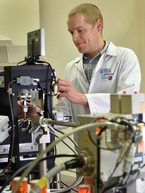 Peter Mace, of the University of Otago biochemistry department, with an X-ray generating machine. Photo by Peter McIntosh.