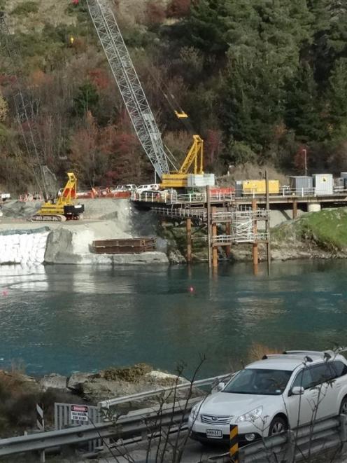 A vehicle crosses the  Kawarau Falls bridge while construction of the  replacement bridge...