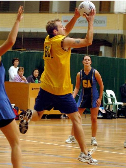 Golden touch . . . Men's premier team goal-shoot Brent Bulmer leaps to catch the ball during his...