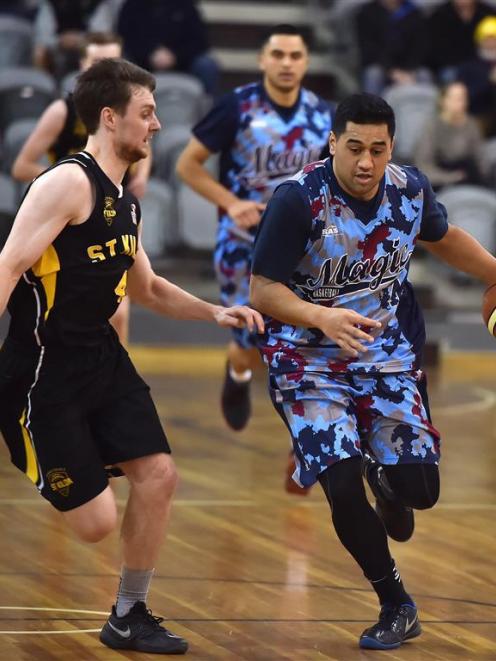 Magic guard Micah Lepaio is pursued by St Kilda Saints guard James Ross during a men’s A grade...