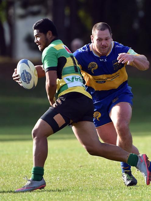 Green Island fullback Sunia Makasini is about to be tackled by Taieri prop Guy Millar during a Dunedin premier club rugby match at Peter Johnstone Park last Saturday. Photo by Peter McIntosh.