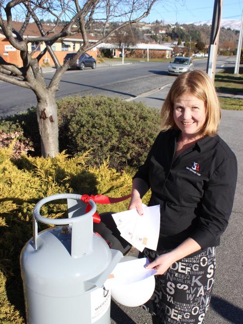Whitestone Post Central Otago operator Diane Williamson posts a letter at the official opening of the Alexandra franchise. Photo: Jono Edwards