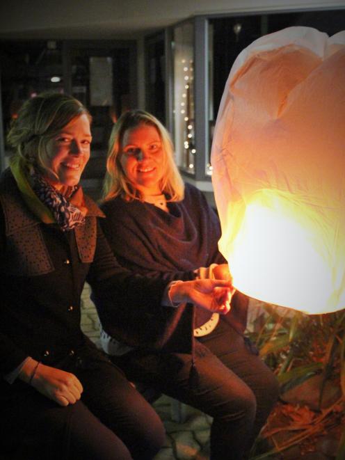 Cromwell and Districts Promotion Groups community relationships manager Brigitte Tait (right) and Carolyn Murray, of Scott Base Winery, try out one of the lanterns to be released at the Light Up Winter event in Cromwell. The new event will be held on Augu