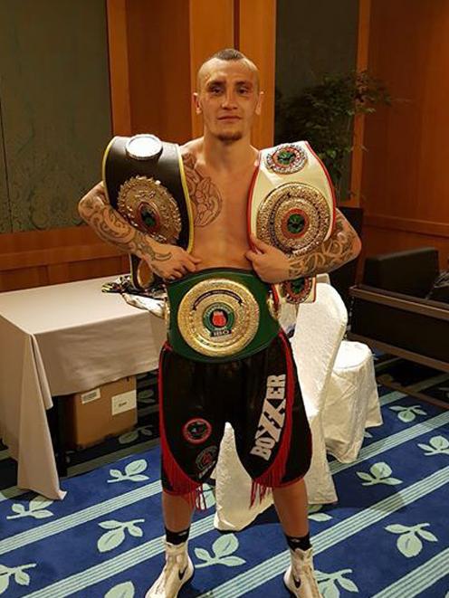 Dunedin boxer Chase Haley poses with his belts after winning the IBO Oceania-Oriental light heavyweight title and two other minor belts in Singapore on the weekend. Photo: Supplied