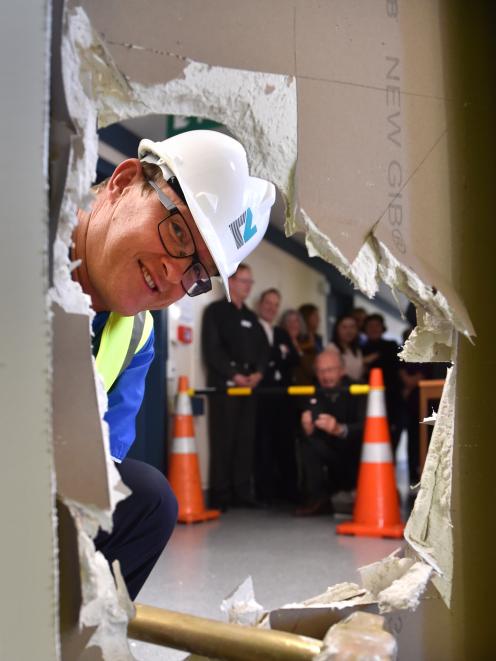 Dunedin Hospital general surgery charge nurse manager Kirk Davidson smashes a hole in a fifth-floor wall at the hospital, to launch the Southern District Health Board's latest interim redevelopment project. Photo: Peter McIntosh