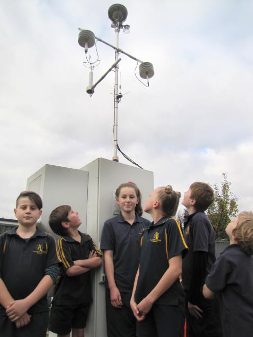 Alexandra Primary School pupils (from left) Cade Roberts (9), Flynn Millar (9), Nika Casbolt (13), Summer Claridge (12), Leon Morris (11), and Josh Cannell (9) check out the new Otago Regional Council air quality monitoring equipment across from their sch