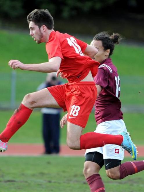 Caversham striker Tore Waechter (left) gets the jump on Dunedin Technical's Logan Mamanu during...