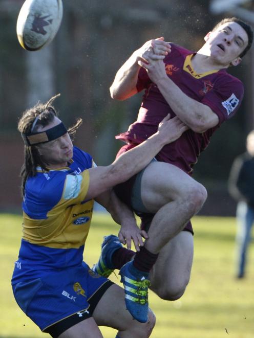 Taieri wing Glen Beadle (left) and Alhambra-Union second five-eighth Legin Felix-Hotham compete for the ball during their premier club match at the North Ground on Saturday. Photo: Gerard O'Brien