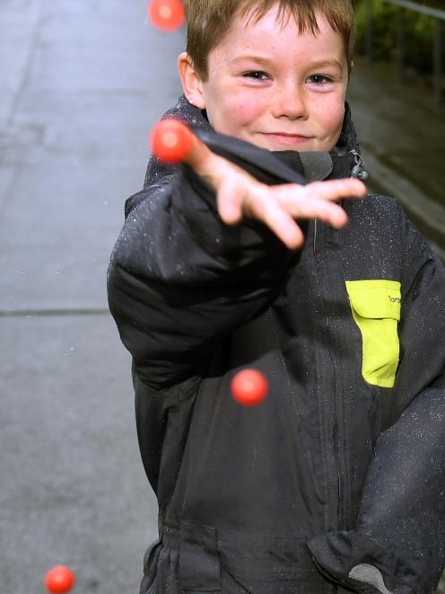 William Hanning (7), of Auckland, throws Jaffas down Baldwin St. Photo: Stephen Jaquiery.