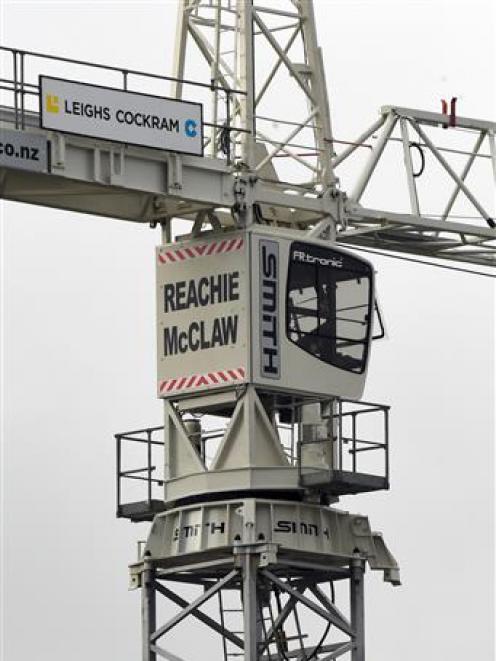 A crane driver climbs to his lofty workplace with its new name displayed on the back of the cab....