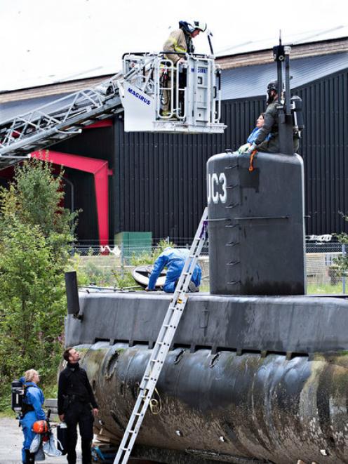 Police technicians investigate the rescued private submarine "UC3 Nautilus" in Copenhagen. Photo: Reuters