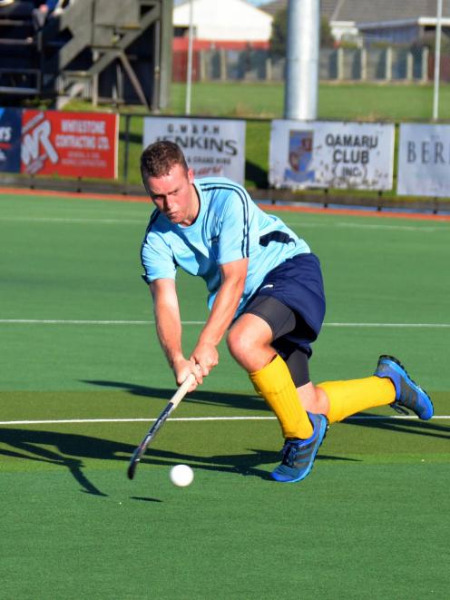 Tainui forward Josh Dalziel sends the ball away during a men’s club hockey game between Tainui...
