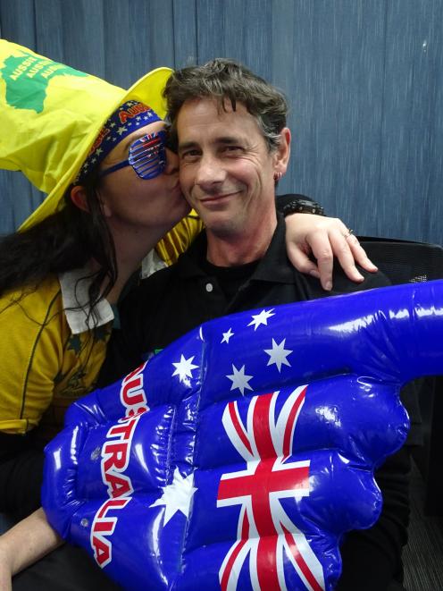 Kingston's Tori Keating, a staunch Wallabies supporter, kisses her husband Malcolm Mackay, a...