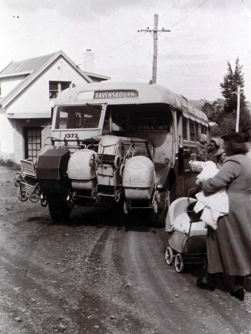 A bus stops at the same spot in the early 1950s.