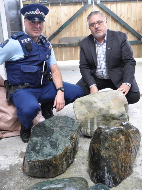 West Coast Police iwi liaison officer Shane Allen (left) and Ngati Waewae chairman Francois Tumahai look over some of the seized stone. Picture: Hokitika Guardian