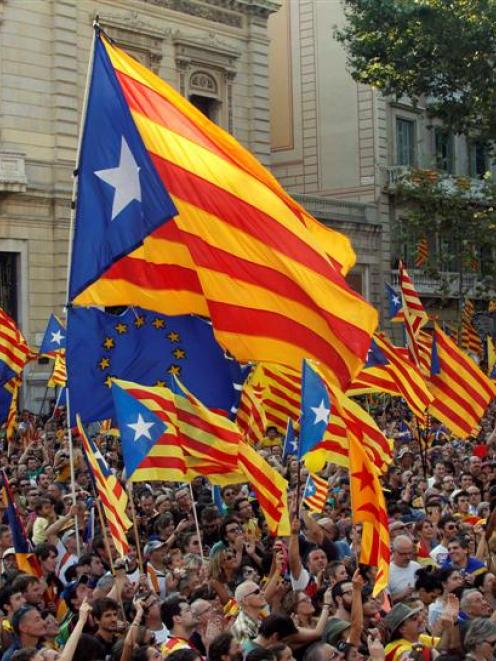 Marchers wave Catalonian nationalist flags as they demonstrate during Catalan National Day in...