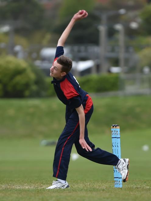 John McGlashan College bowler Ben Hatton (15) sends down a delivery during the final of the...