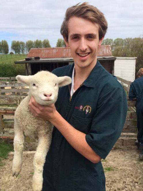 Veterinary science student Paul Blondell gets up close with a lamb. PHOTO: SUPPLIED
