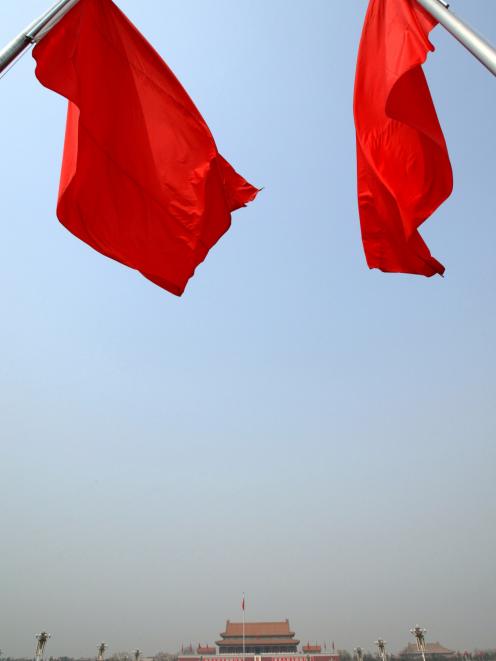 Red flags, in this file photo, fly over Tiananmen Gate,  where the late chairman Mao Zedong...