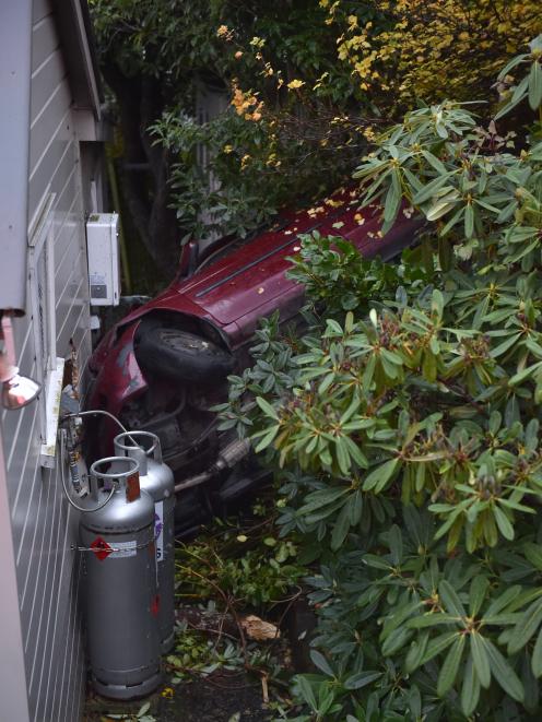 The victim’s car ploughed through shrubbery and over a retaining wall into a house on Greenock St...