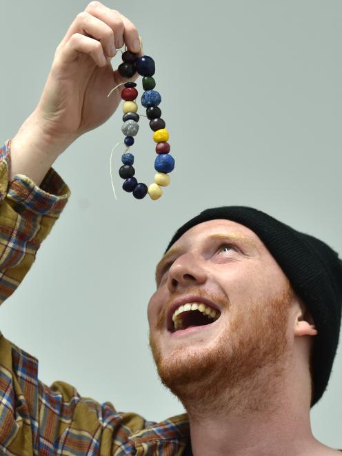 Otago Polytechnic visual arts (honours) student Brogan Nuttall (23) admires his piece of...