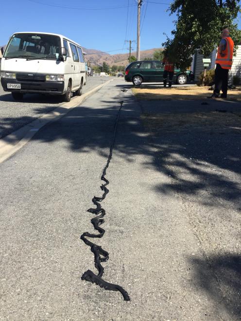 Protective coating from power lines in Ray St, Cromwell, lies on the ground after melting off during a power surge when an Aurora contractor damaged a nearby low-voltage underground cable. Photo: Denise McNabb