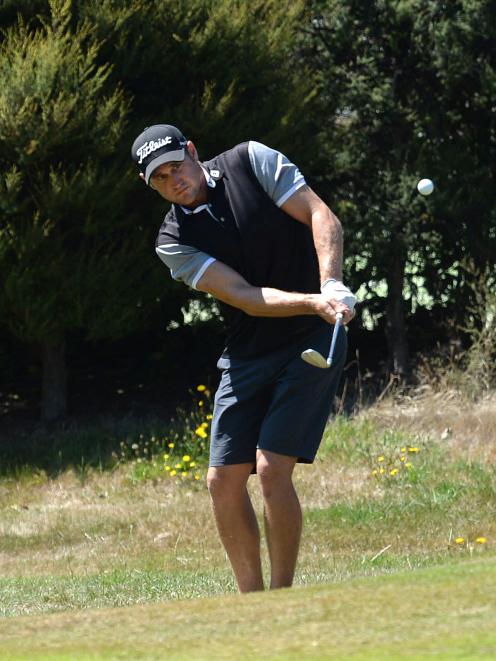 Blake Mason, of Wanaka, plays a chip shot on the 14th fairway in the first stage of qualifying...