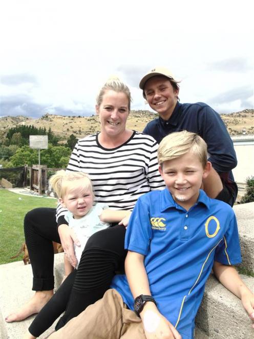 Child cancer ambassador Caleb Darling (10, front) with his sister Emmie (2), mother Genna and brother Brayden (14). The plaster on Caleb's chin is just from the normal scrapes of a 10-year-old. PHOTO: SIMON HENDERSON