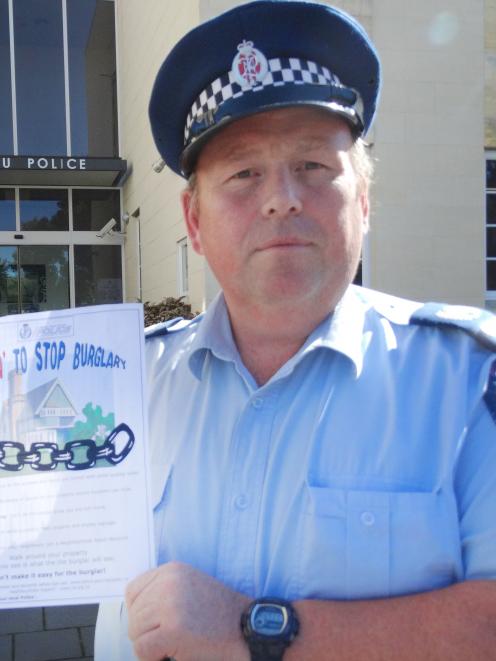 Senior Sergeant Jason McCoy, of Oamaru, with a home security questionnaire being handed out to...