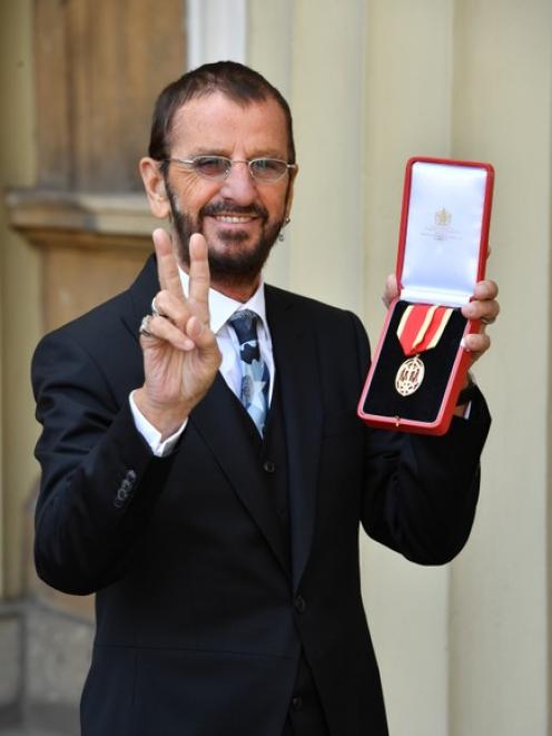 Ringo Starr, whose real name is Richard Starkey, poses after receiving his Knighthood. Photo: Reuters