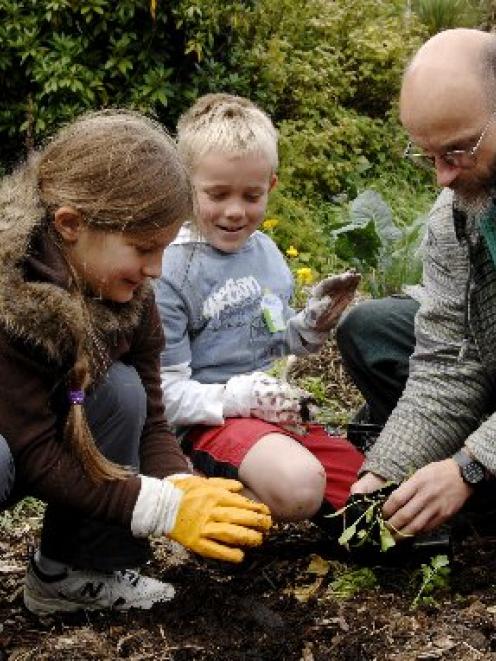 Dunedin Environment Centre trustee Joseph Dougherty instructs Macandrew Bay School pupils Katie...