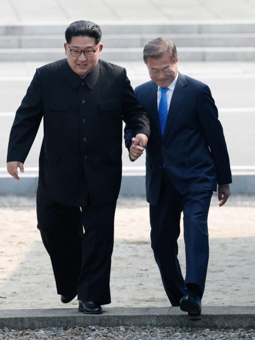 The pair go back across the military demarcation line to the south side after Moon Jae-in crossed...