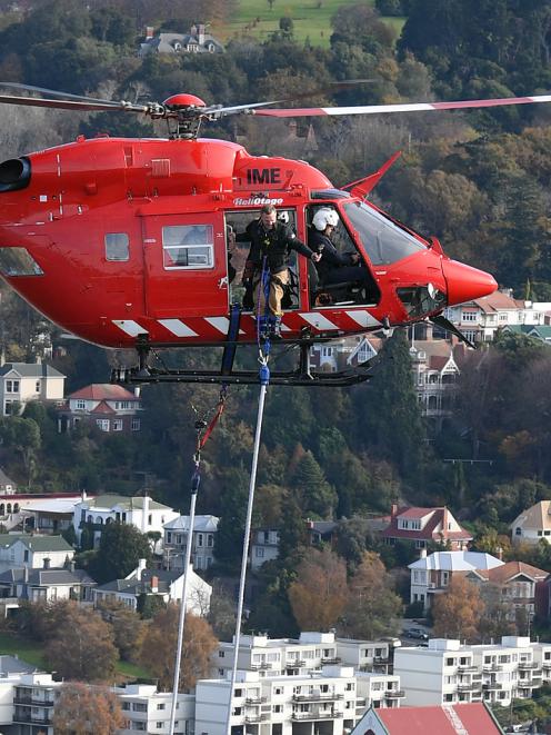 Henry van Asch prepares to launch himself out of a helicopter over Otago Harbour this morning....