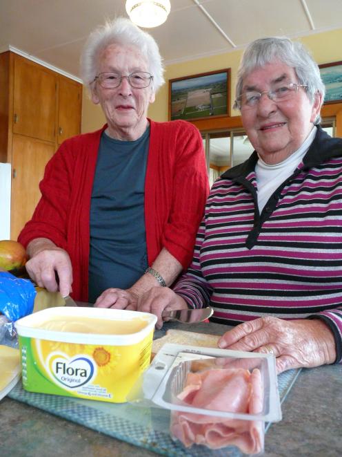 Retiring Tokomairiro Ploughing Competition catering volunteers Nancy Allison (left) and Joan Thornthwaite, both of Milton, assemble one final sandwich. The pair have catered the event since 1959. Photo: Richard Davison