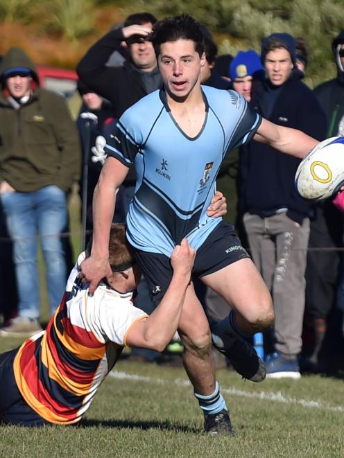 King’s High School winger Nathan Hastie is tackled by John McGlashan College  hooker George Bell...