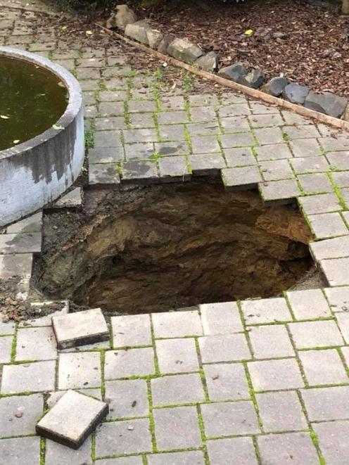 The hole in the patio at Andrew Thomson's Portobello home. Photo: Andrew Thomson via RNZ