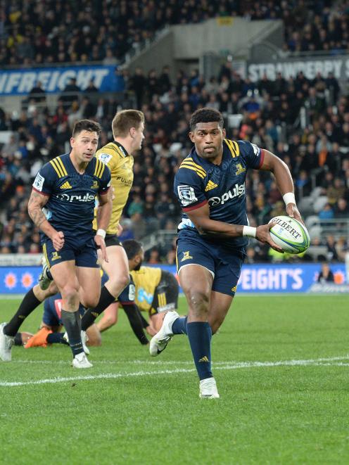 Highlanders wing Waisake Naholo makes a burst supported by flanker Rob Thompson (left)....