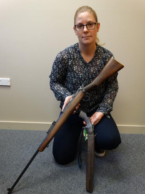 Detective Sergeant Hannah Booth, of Oamaru, with two firearms recently seized as a result of the...